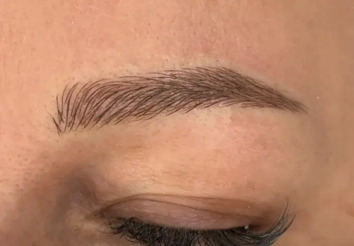 Efekt naturalnych brwi po zabiegu microblading. Delikatne włoski podkreślają kształt oka.